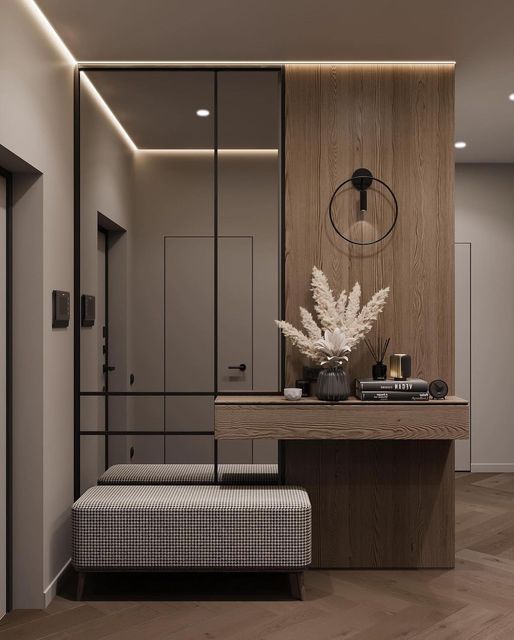 Modern hallway interior with wooden accents, wall mirror, decorative pampas grass vase, and cozy plaid bench seating.