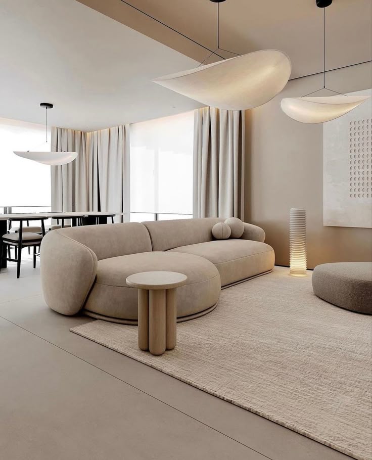 Modern minimalist living room with beige sofa, stylish lighting, and neutral decor.
