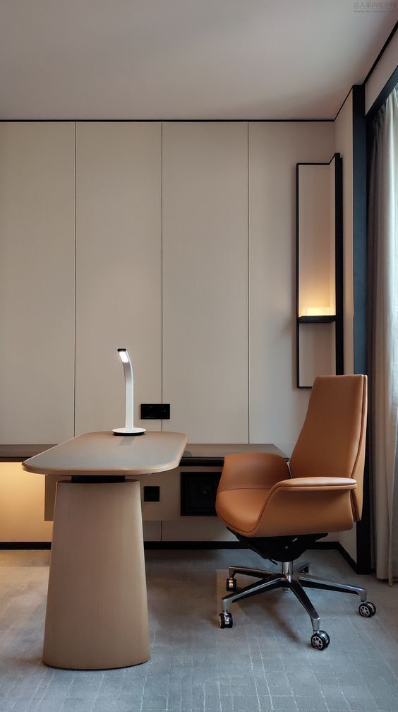 Modern office with sleek desk, ergonomic chair, and stylish lighting, offering a minimalist and functional workspace.
