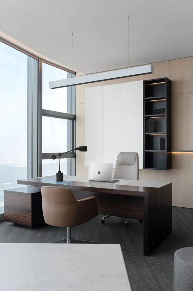 Modern office with sleek desk, leather chairs, and large windows offering a stunning view. Minimalist decor.