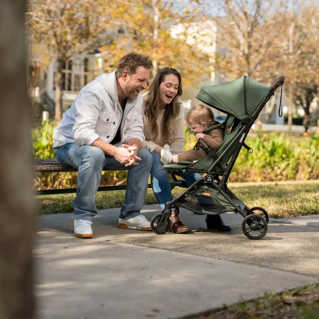 Family enjoys a sunny day in the park, sitting on a bench with a baby in a stroller.