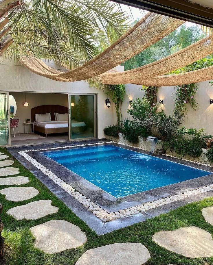 Luxury villa with private pool, tropical garden, and open-air bedroom view for a serene getaway.