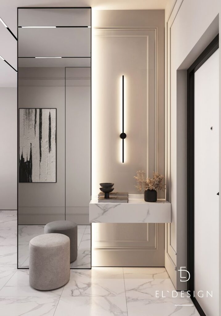 Modern entryway with mirror, sleek wall light, marble console, and minimalist decor. Elegant interior design.
