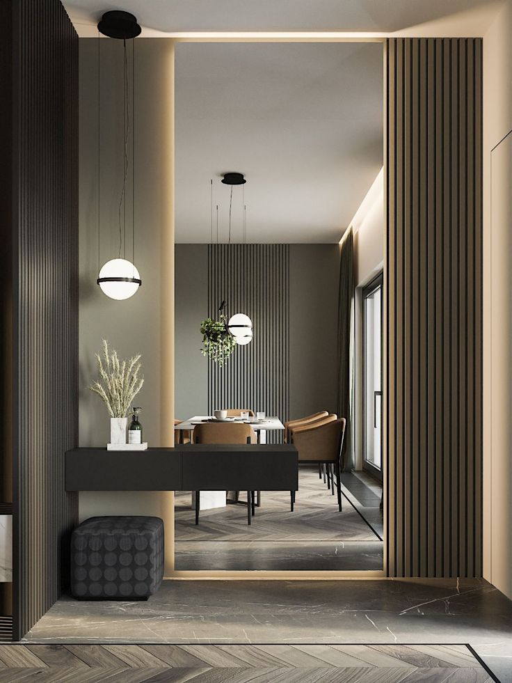 Modern dining room with sleek decor, hanging lights, and wooden panel accents, creating a cozy, minimalist atmosphere.