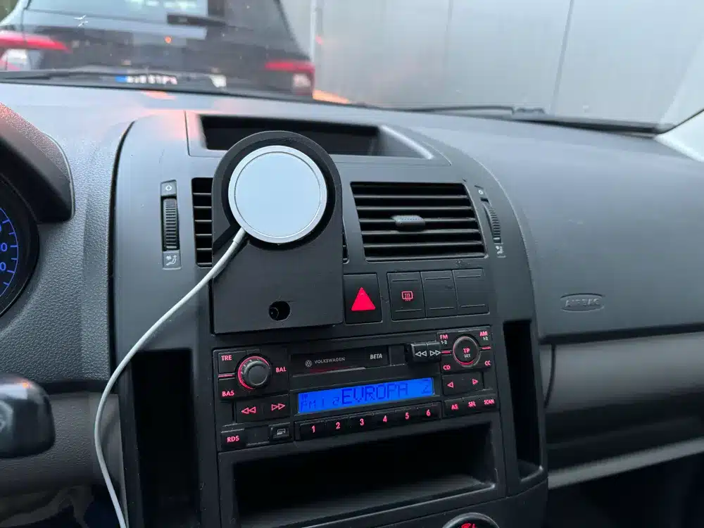 Car dashboard with phone mount and radio display showing EUROPA 2.