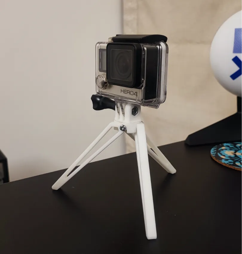 Action camera on a compact tripod, perfect for capturing high-quality adventure footage indoors.