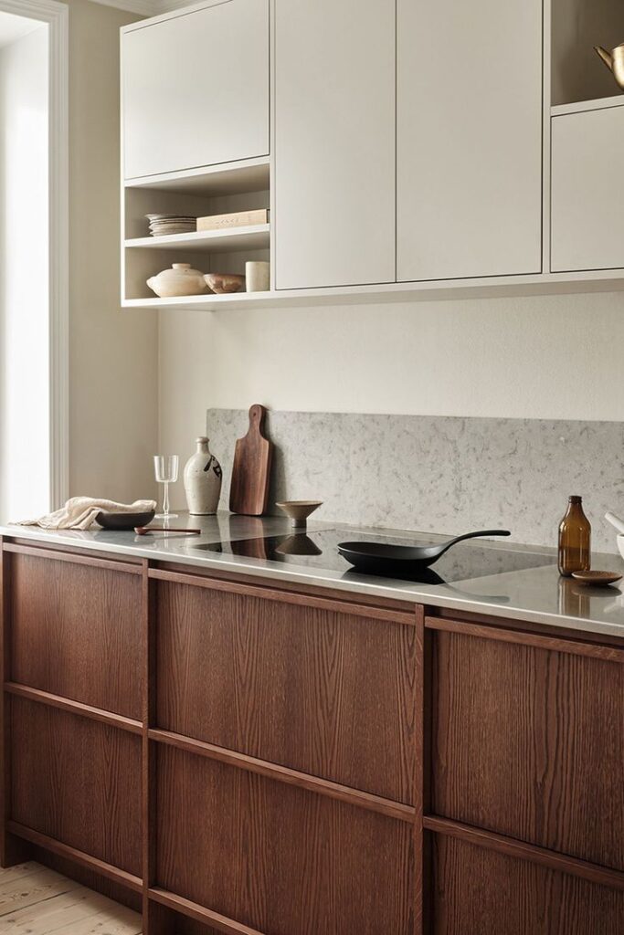 Minimalist kitchen with wooden cabinets, marble countertop, and modern decor for a sleek, contemporary design.