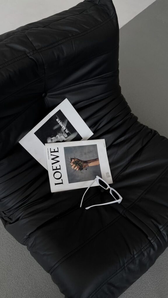 _ - 2025-05-14T103147917 Magazines and white sunglasses on a black leather chair, featuring stylish photography covers. | Sky Rye Design Magazines and white sunglasses on a black leather chair, featuring stylish photography covers.