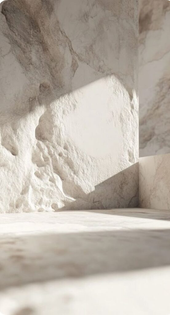 Sunlit textured marble wall with shadows, ideal for minimalist interior design concepts and architectural inspiration.