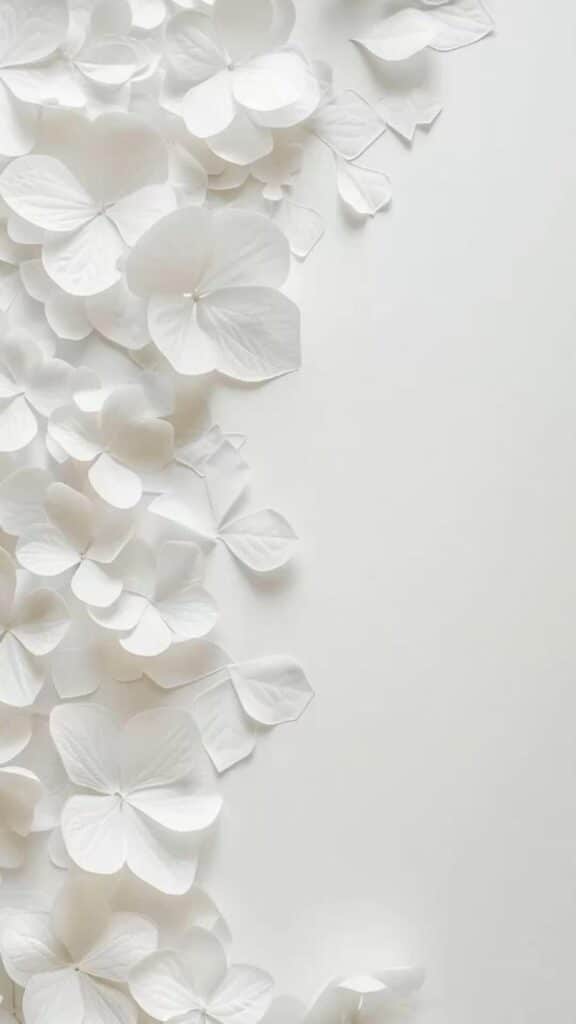 Elegant white paper flowers cascading on a light background, creating a minimalistic and serene decorative effect.