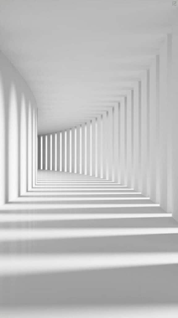 Minimalist white hallway with shadows from pillars creating a geometric pattern and depth effect.