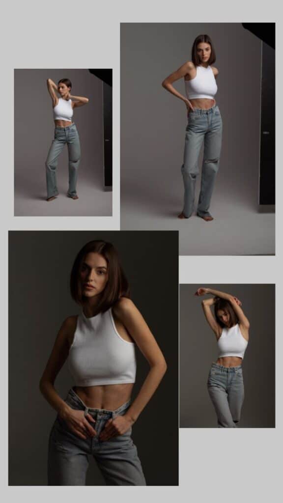 Woman poses confidently in casual jeans and white crop top against a neutral studio background. Fashion photography.