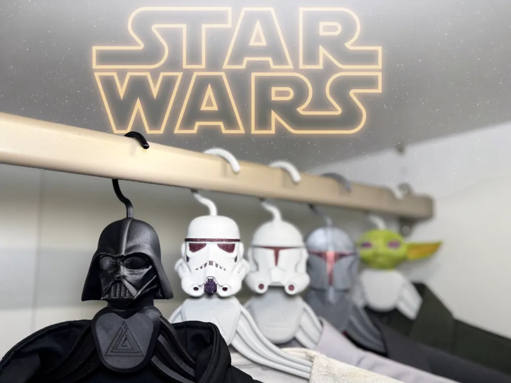 Star Wars-themed clothes hangers with character helmets in a closet.