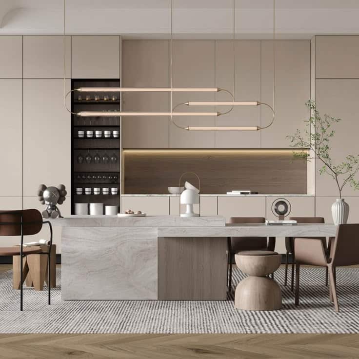 Modern kitchen with beige cabinets, marble island, unique pendant light, and contemporary decor elements.