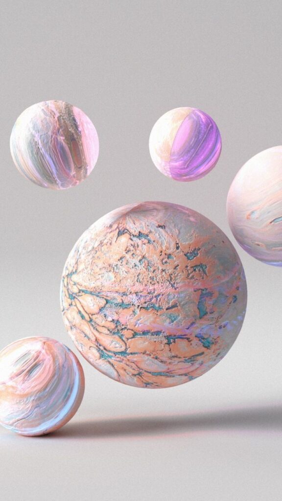 Colorful abstract planets with pastel textures floating in a soft gray space background.