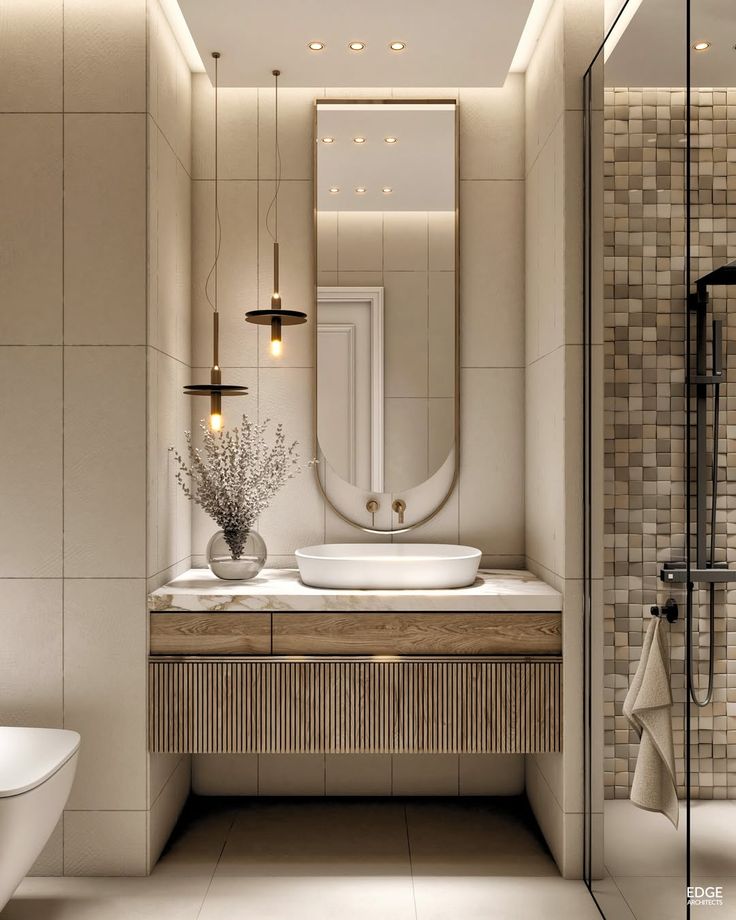 Modern bathroom with stylish vanity, round mirror, pendant lighting, and decorative vase for contemporary elegance.
