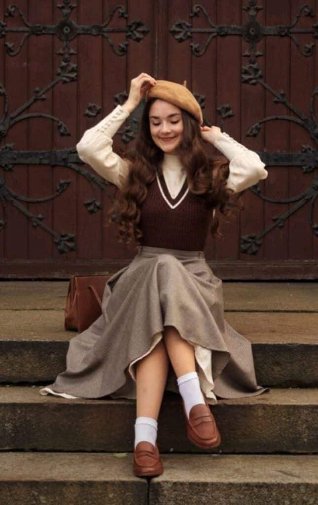 31bf0009-a189-4244-96a9-9bbc9b968fda Woman in vintage outfit with beret, sitting on steps, smiling. | Sky Rye Design Woman in vintage outfit with beret, sitting on steps, smiling.