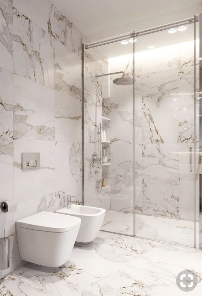 _ 34 Luxurious marble bathroom with glass shower, modern toilet, and bidet. | Sky Rye Design Luxurious marble bathroom with glass shower, modern toilet, and bidet.