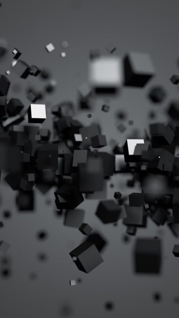 Floating black and white cubes in a minimalist, abstract 3D space with a gray background.
