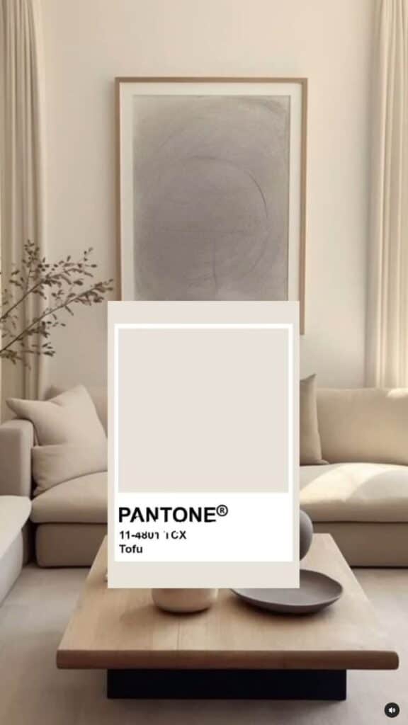 Minimalist living room with beige tones, featuring Pantone Tofu color sample and neutral decor elements.