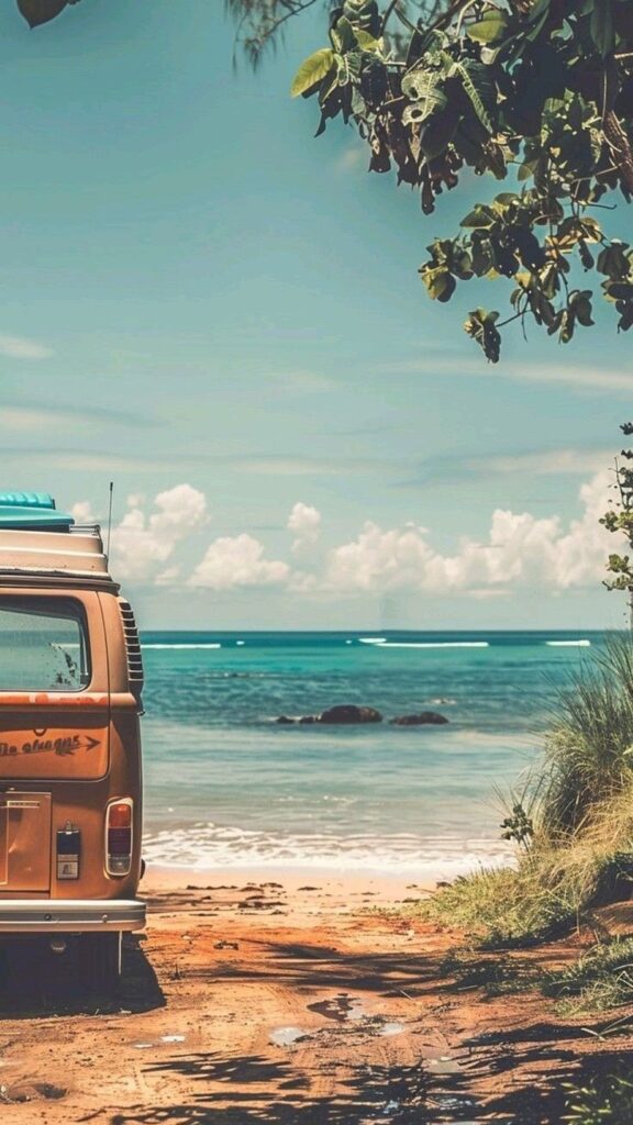 Vintage van parked by the beach, ocean waves and clear sky in background, lush greenery overhead.