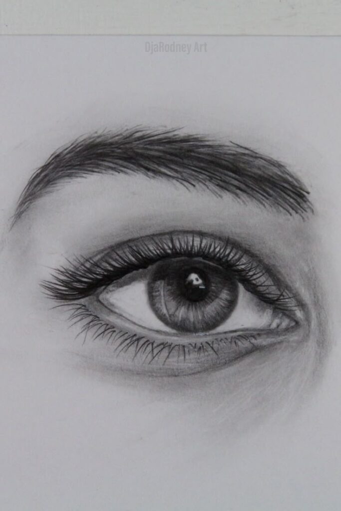 Detailed pencil sketch of a realistic eye with shading, featuring long eyelashes and a textured eyebrow.