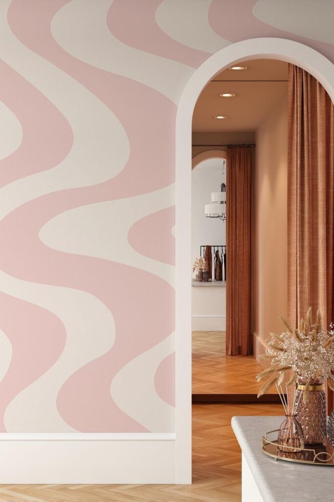 Modern interior with pink wavy wallpaper, archway, and elegant decor in a well-lit room.