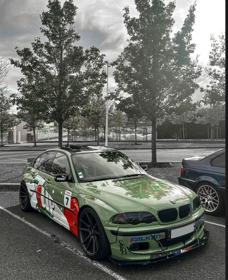 Green race car with 7UP branding parked under trees on a cloudy day.
