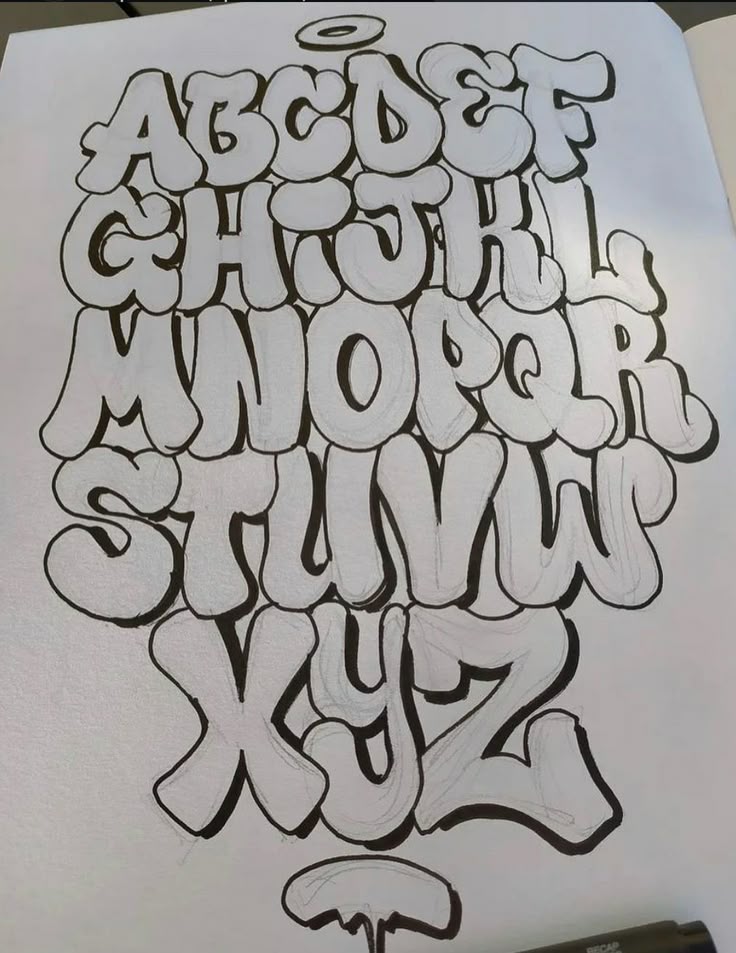 Stylized graffiti-style alphabet sketch on paper, showcasing bold black-and-white letters, A to Z.