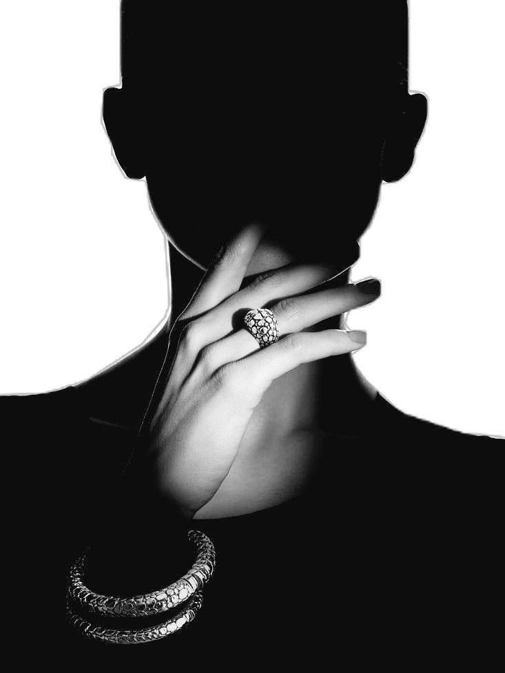 Elegant silhouette with shimmering rings and bracelets, highlighting luxury jewelry in black and white.