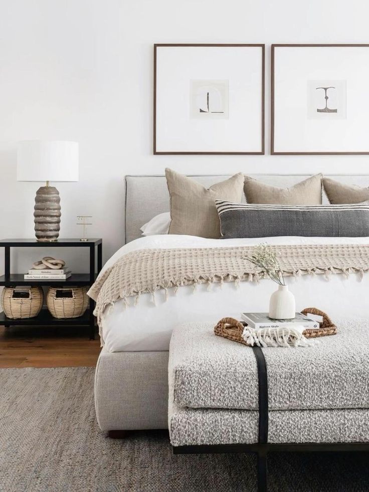 Modern bedroom with cozy neutral decor, stylish gray bed, and elegant accessories on a white and beige palette.