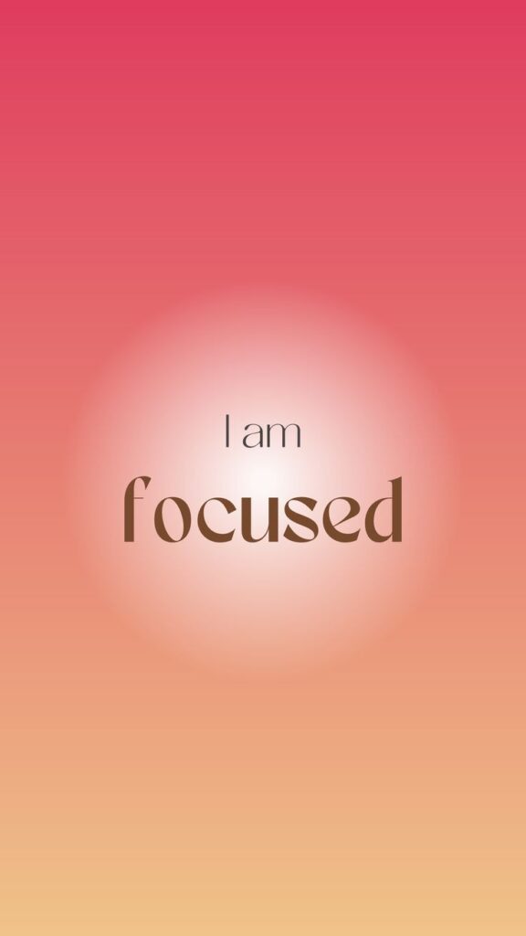 Pink and orange gradient background with 'I am focused' motivational text centered.