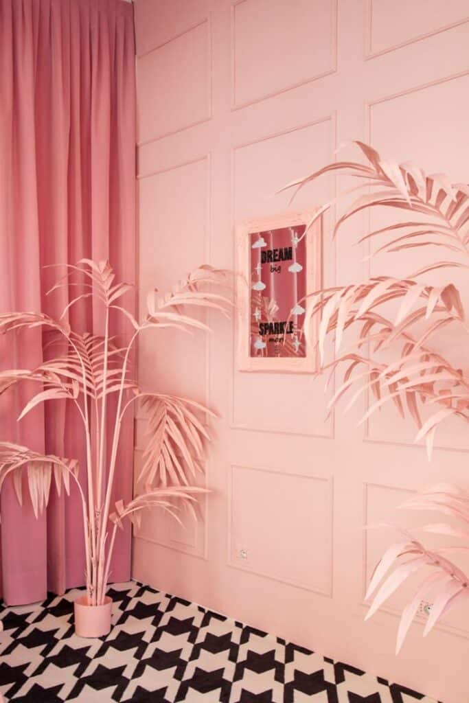 Pink room with palm decor, geometric rug, motivational Dream big, sparkle more mirror, elegant interior design.