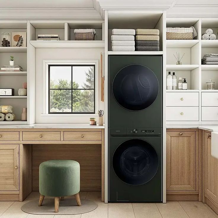 Modern laundry room with black stacked washer and dryer, wooden cabinets, shelves, and a green stool.
