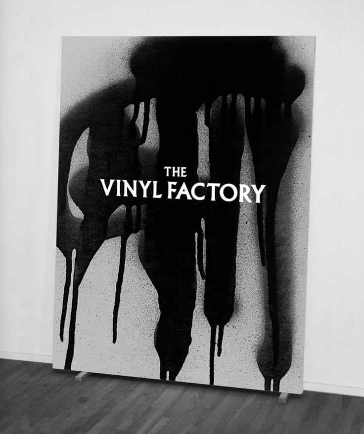Black and white abstract art with The Vinyl Factory text, featuring bold, dripping paint designs.