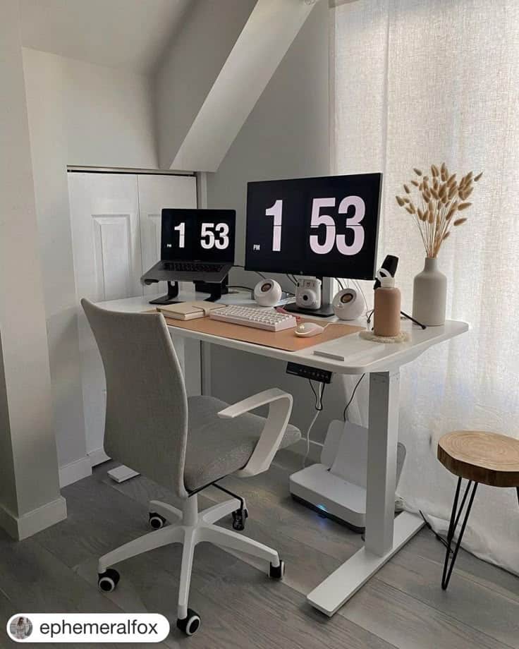 Modern home office setup with dual monitors, ergonomic chair, and minimal decor in natural light.