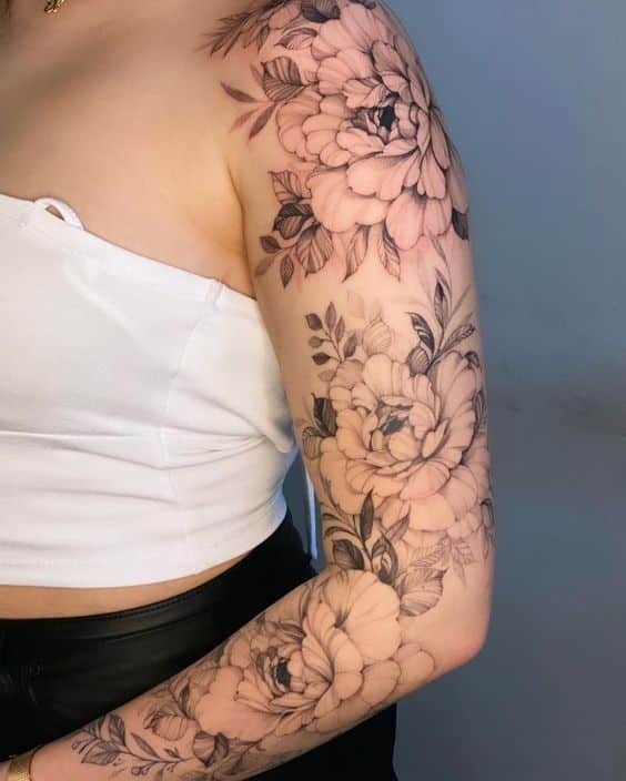 83ce17ce-9661-4b68-b79d-bde67a44a950 Floral sleeve tattoo on arm, featuring detailed roses and leaves in black ink. | Sky Rye Design Floral sleeve tattoo on arm, featuring detailed roses and leaves in black ink.