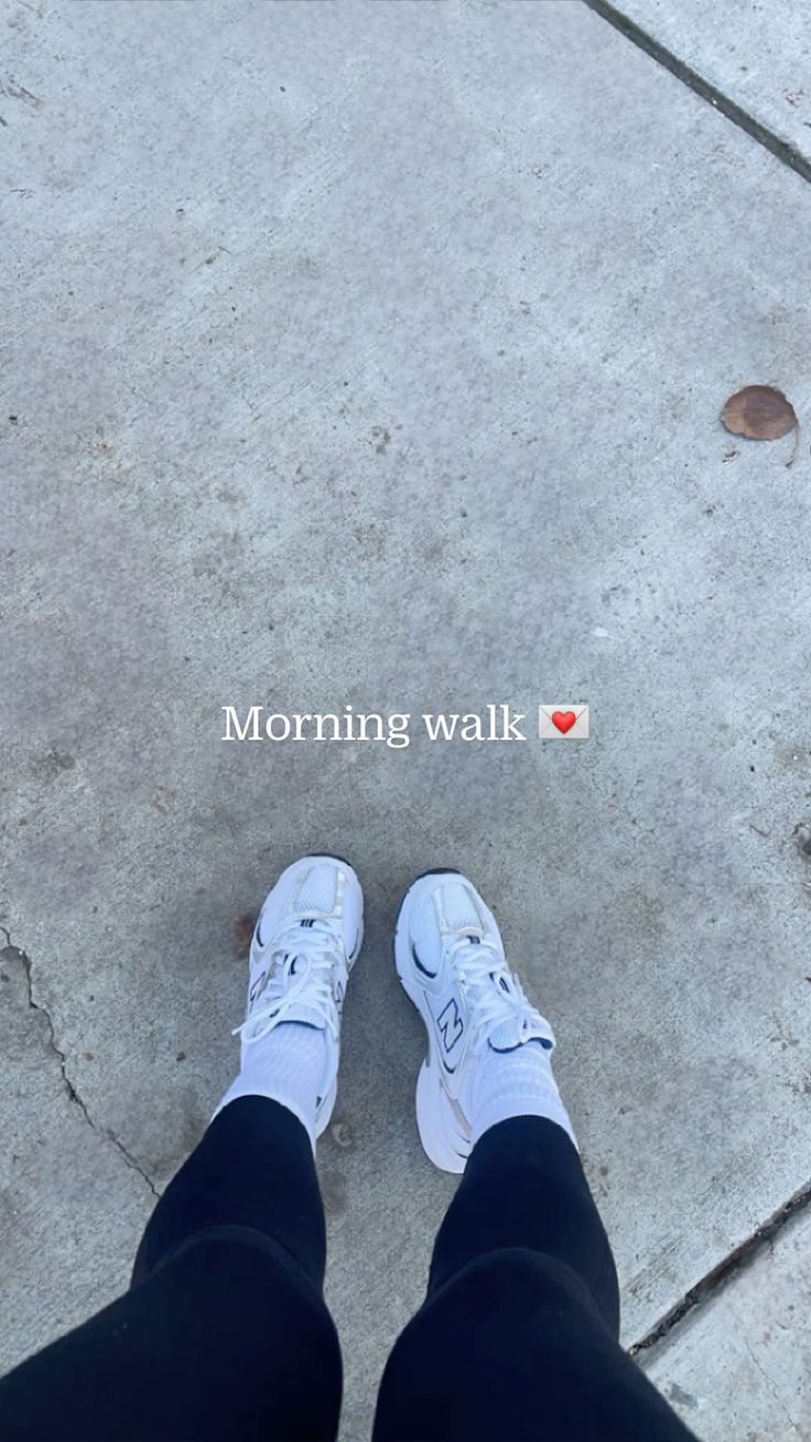 Person wearing white sneakers on a sidewalk, text Morning walk with a heart emoji. Casual fitness vibes.