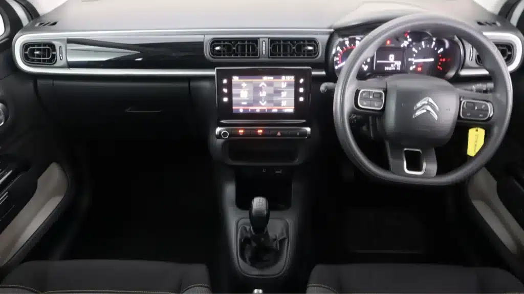 915 Modern car interior with touchscreen display, steering wheel, dashboard, and gear shift in focus. | Sky Rye Design Modern car interior with touchscreen display, steering wheel, dashboard, and gear shift in focus.