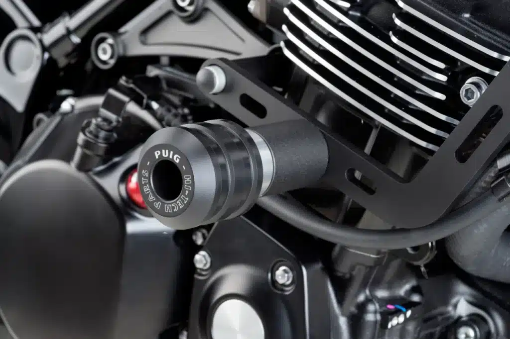 Close-up of a Puig motorcycle engine slider, showcasing high-tech parts and durability.