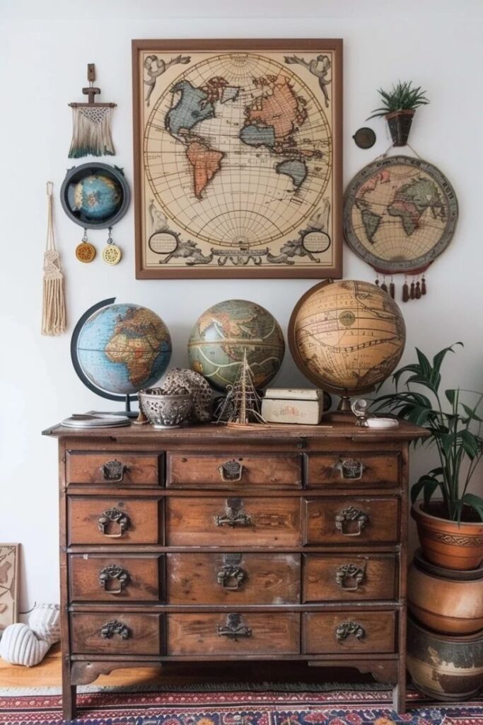 Vintage globes and world maps displayed on a wooden dresser, creating a classic travel-themed decor setting.