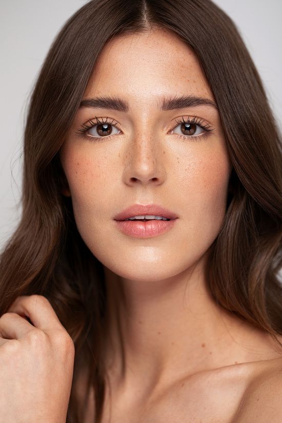 BEAUTY FASHION - Holly Broomhall Photographer OFFICIAL WEBSITE Close-up of a woman with long brown hair and natural makeup, highlighting smooth skin and freckles. | Sky Rye Design Close-up of a woman with long brown hair and natural makeup, highlighting smooth skin and freckles.