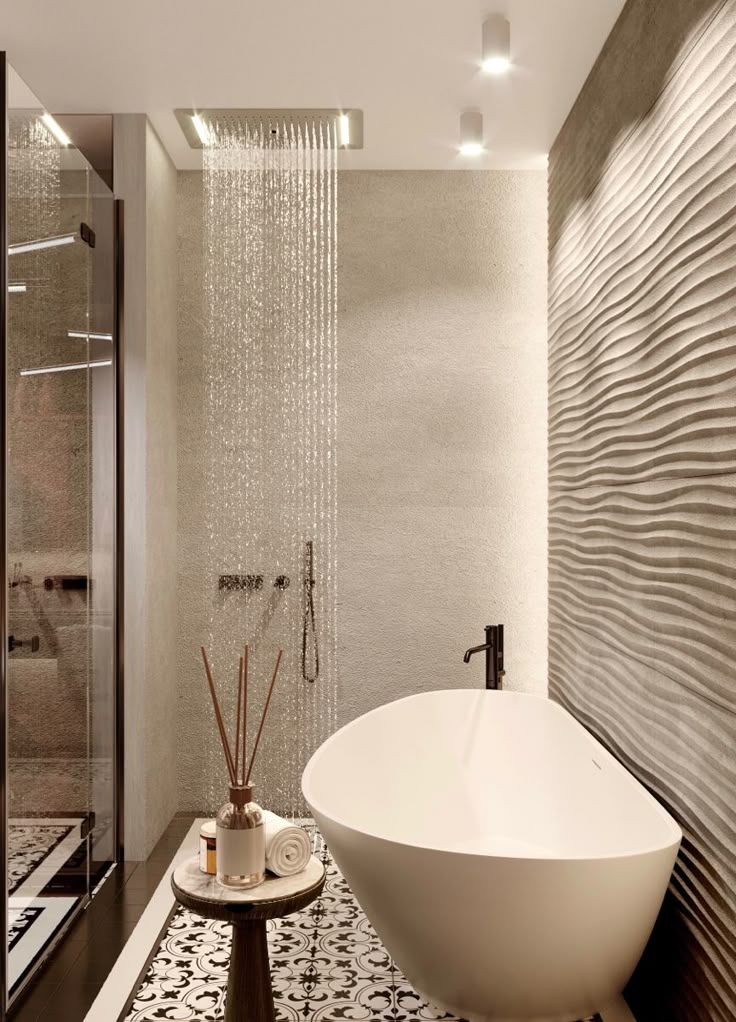 Luxurious bathroom with freestanding tub, textured walls, and rain shower, accentuated by modern lighting.