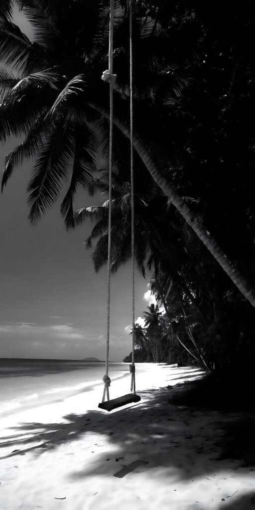 Tropical beach swing under palm trees in black and white, serene coastal scene with gentle waves and shadows.