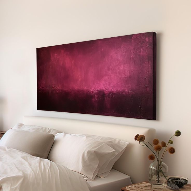 Modern bedroom with abstract red artwork above bed, white bedding, and decorative plants for a cozy ambiance.