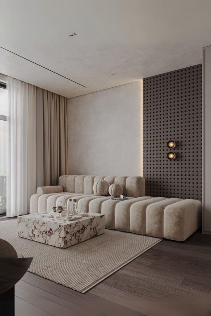 Modern living room with a beige modular sofa, marble coffee table, and textured accent wall.