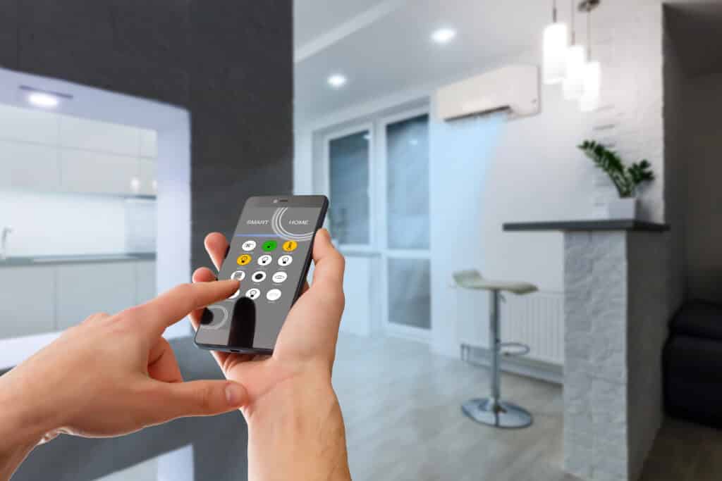 Person controlling smart home devices from smartphone in modern living room.