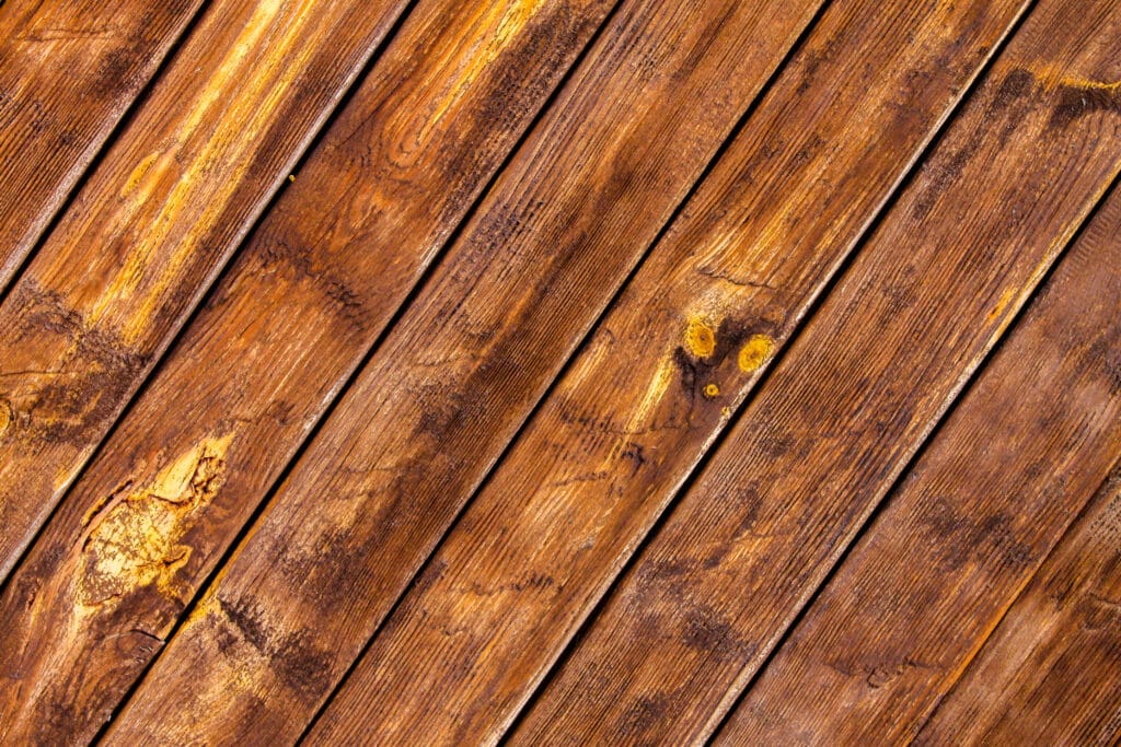 Wooden texture background with diagonal planks, showcasing natural grain and warm brown tones.