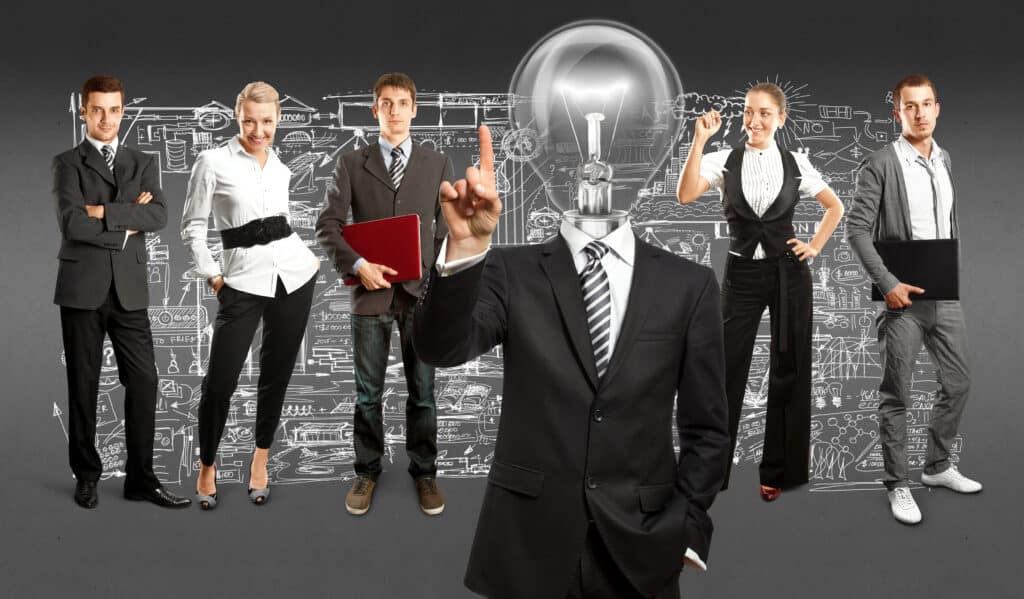 Business team with headless leader having a lightbulb for a head, symbolizing innovation and teamwork.