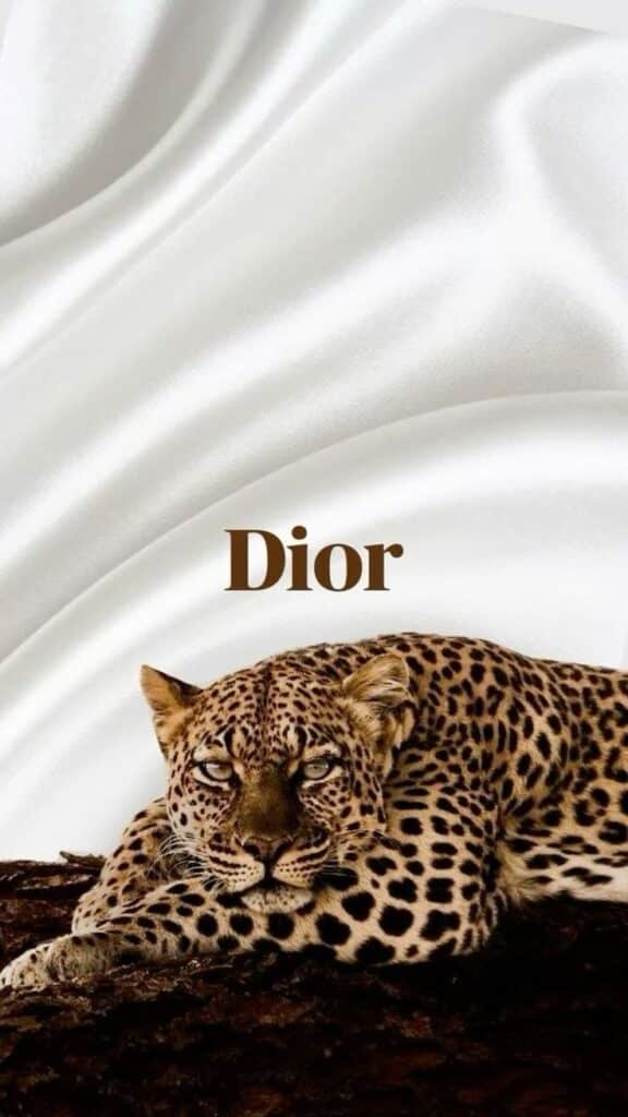 Leopard resting on fabric, with Dior text in elegant font. Luxury and elegance concept. iPhone Wallpaper Pattern